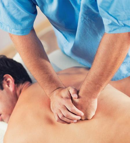 Therapist working on a client's back during a sports / rehab massage